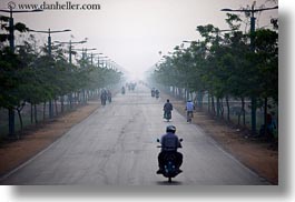 asia, cambodia, hazy, horizontal, lined, motorcycles, roads, transportation, trees, photograph