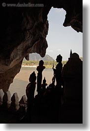asia, buddhist, buildings, cave temple, laos, luang prabang, silhouettes, statues, temples, vertical, photograph
