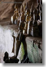 asia, buddhas, buildings, cave temple, caves, figurines, laos, luang prabang, temples, vertical, photograph