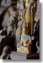 asia, buddhas, buildings, cave temple, caves, figurines, laos, luang prabang, temples, vertical, photograph