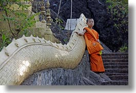 asia, asian, boy and stairs, boys, colors, horizontal, laos, luang prabang, men, monks, oranges, people, snakes, stairs, photograph