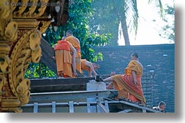 asia, asian, buildings, colors, horizontal, laos, luang prabang, men, monks, oranges, people, roofs, photograph