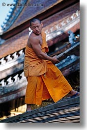 asia, asian, buildings, colors, laos, luang prabang, men, monks, oranges, people, roofs, vertical, photograph