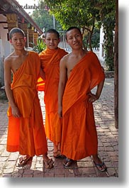 asia, asian, boys, colors, laos, luang prabang, men, monks, oranges, people, portraits, threes, vertical, photograph