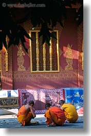 asia, asian, colors, laos, luang prabang, men, monks, oranges, people, squatting, temples, vertical, photograph