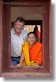 asia, asian, colors, laos, luang prabang, men, monks, oranges, people, tourists, vertical, windows, photograph