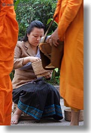alms, asia, asian, colors, giving, giving alms, laos, luang prabang, men, monks, oranges, people, procession, vertical, womens, photograph