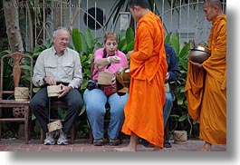 alms, asia, asian, colors, giving, giving alms, horizontal, laos, luang prabang, men, monks, oranges, people, procession, womens, photograph