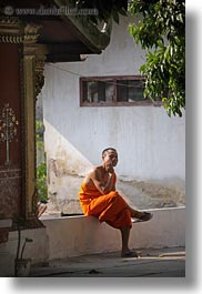 asia, asian, colors, laos, luang prabang, men, monks, oranges, people, shades, singles, sitting, vertical, photograph