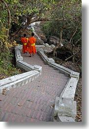 asia, asian, colors, down, laos, long, luang prabang, men, monks, oranges, people, stairs, two, vertical, walking, photograph