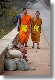 asia, asian, colors, laos, luang prabang, men, monks, oranges, people, sidewalks, smiling, two, vertical, photograph
