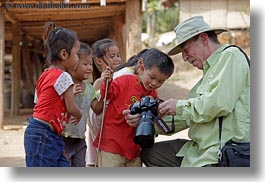 asia, asian, cameras, childrens, clothes, emotions, groups, hats, horizontal, laos, men, people, river village, showing, smiles, tourists, villages, photograph