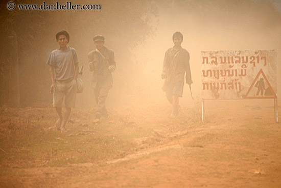 people-walking-in-dust-by-sign.jpg