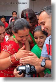 asia, bindi, cameras, emotions, girls, hashmat, hindu, jewelry, kathmandu, nepal, pashupatinath, people, religious, showing, sindoor, smiles, teenagers, tikka, vertical, photograph