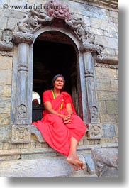 archways, asia, bindi, hindu, jewelry, kathmandu, nepal, pashupatinath, religious, sindoor, sitting, tikka, under, vertical, womens, photograph