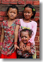 asia, babies, crying, emotions, girls, kathmandu, nepal, patan darbur square, smiles, smiling, vertical, womens, photograph