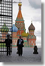 asia, buildings, churches, colorful, colors, gates, guards, irons, landmarks, materials, men, moscow, onion dome, pedestrians, people, religious, russia, st basil, st basil cathedral, structures, vertical, photograph