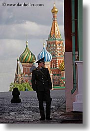 asia, buildings, churches, colorful, colors, guards, landmarks, men, moscow, onion dome, people, religious, russia, st basil, st basil cathedral, structures, vertical, photograph