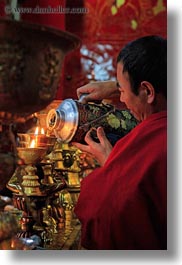 asia, candles, ganden monastery, glow, lhasa, lights, monks, tibet, vertical, photograph