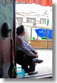 asia, buddhist, doors, lhasa, men, people, religious, sitting, temples, tibet, vertical, photograph