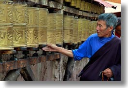 asia, buddhist, cans, horizontal, lhasa, men, people, prayers, religious, temples, tibet, turning, photograph