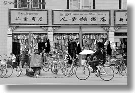 asia, asian, bikes, black and white, colorful, horizontal, language, lhasa, shops, stores, tibet, photograph
