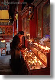 asia, asian, candles, lighting, people, style, tan druk temple, tibet, vertical, womens, photograph