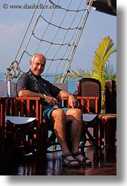 asia, bald, boats, chairs, ha long bay, men, nets, people, ships, smiling, vertical, victory ship, vietnam, photograph