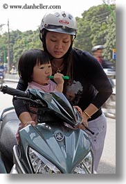asia, childrens, girls, hanoi, mothers, motorcycles, people, toddlers, vertical, vietnam, photograph