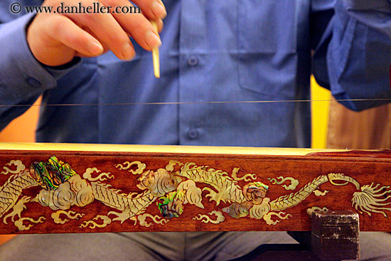 large string instrument played with fingers large string instrument played with fingers