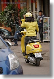 asia, hanoi, motorcycles, people, vertical, vietnam, womens, yellow, photograph