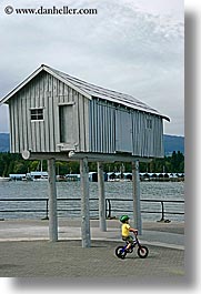 bicycles, bikes, boys, canada, childrens, houses, people, stilts, vancouver, vertical, photograph