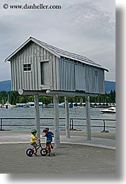 bicycles, bikes, boys, canada, childrens, houses, people, stilts, vancouver, vertical, photograph