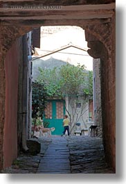 arches, archways, childrens, cobblestones, croatia, dogs, europe, groznjan, materials, narrow streets, playing, stones, streets, structures, vertical, photograph