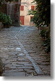 cobblestones, croatia, europe, groznjan, materials, narrow streets, plants, roads, stones, streets, vertical, photograph