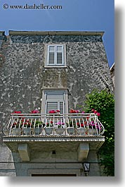 balconies, croatia, europe, flowers, korcula, statues, vertical, windows, photograph