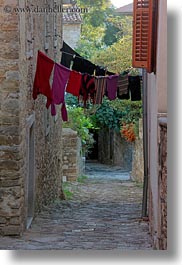 cobblestones, croatia, europe, hangings, laundry, materials, motovun, narrow, narrow streets, stones, streets, towns, vertical, photograph