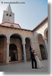 archways, brides, cobblestones, couples, croatia, europe, events, groom, materials, men, people, porec, stones, structures, vertical, wedding, womens, photograph