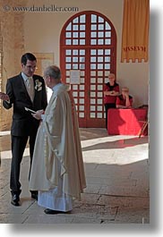 archways, christian, churches, cobblestones, croatia, europe, events, groom, materials, porec, priests, religious, stones, structures, vertical, wedding, photograph