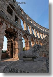 amphitheater, architectural ruins, archways, buildings, croatia, europe, lions, pula, roman, structures, vertical, photograph