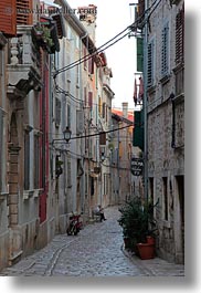 cobblestones, croatia, europe, materials, men, motorcycles, narrow, narrow streets, rovinj, sitting, stones, streets, vertical, photograph