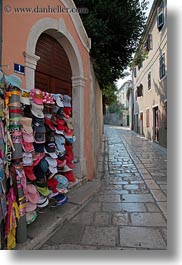 cobblestones, croatia, europe, hats, racks, streets, veli losinj, vertical, photograph