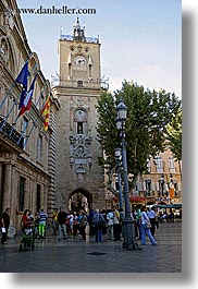aix en provence, buildings, city hall, clock tower, crowds, europe, flags, france, pedestrians, people, provence, streets, structures, towers, vertical, photograph