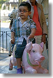 aix en provence, boys, childrens, emotions, europe, france, humor, merry go round, people, pigs, provence, rides, toddlers, vertical, photograph