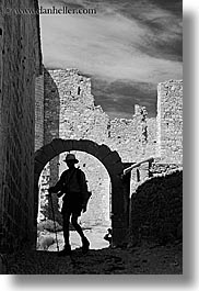 archways, bargeme, black and white, buildings, castles, europe, france, hikers, hiking, materials, men, people, provence, silhouettes, stones, structures, vertical, photograph