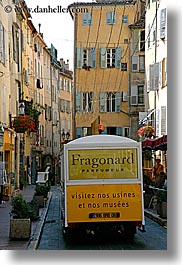 buildings, europe, france, grasse, provence, structures, tourists, trains, vertical, yellow, photograph