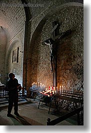 buildings, candles, churches, crosses, europe, france, materials, men, monestaries, moustiers, notre dame de beauvoir, people, provence, religious, st marie, stones, structures, vertical, photograph