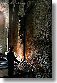 buildings, candles, churches, crosses, europe, france, materials, monestaries, moustiers, notre dame de beauvoir, people, provence, religious, st marie, stones, structures, vertical, womens, photograph