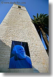 banners, blues, colors, europe, france, hubert, materials, nature, palm trees, plants, provence, reeves, st paul, stones, towers, trees, vertical, photograph