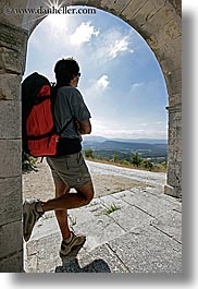 arches, archways, backpack, clothes, clouds, colors, europe, france, groups, men, nature, nicos, people, provence, red, sky, structures, sun, vertical, photograph